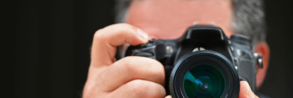 Man photographer photographing with a camera