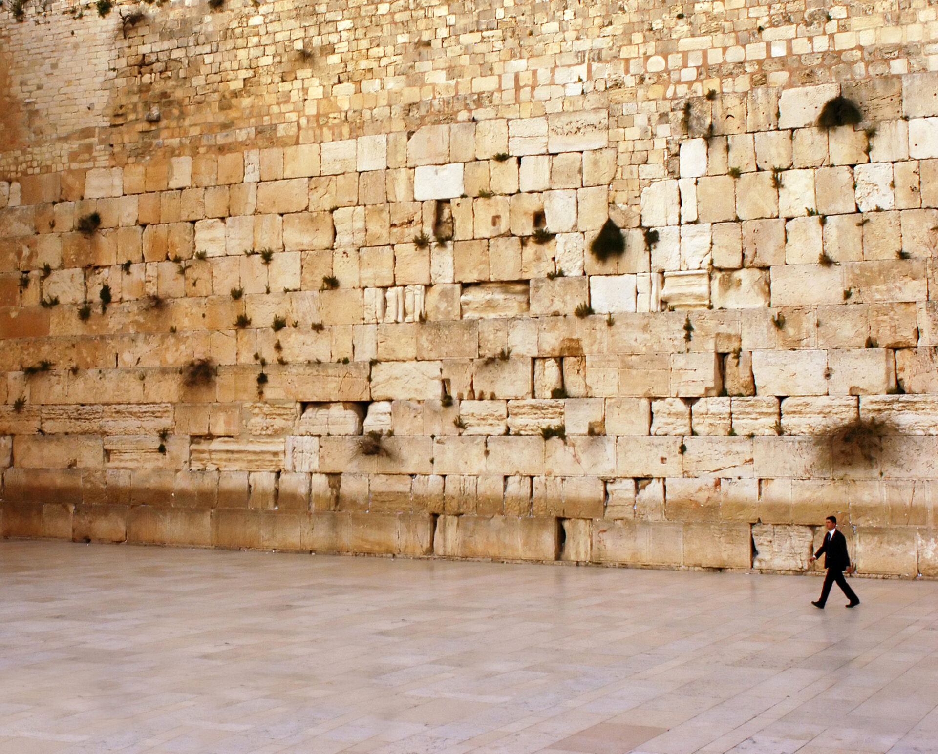 One Jewish orthodox man at Kotel Wailing Western Wall, remnant of the Jewish Temple's the most sacred site recognized by the Jewish faith outside of the Temple Mountain.