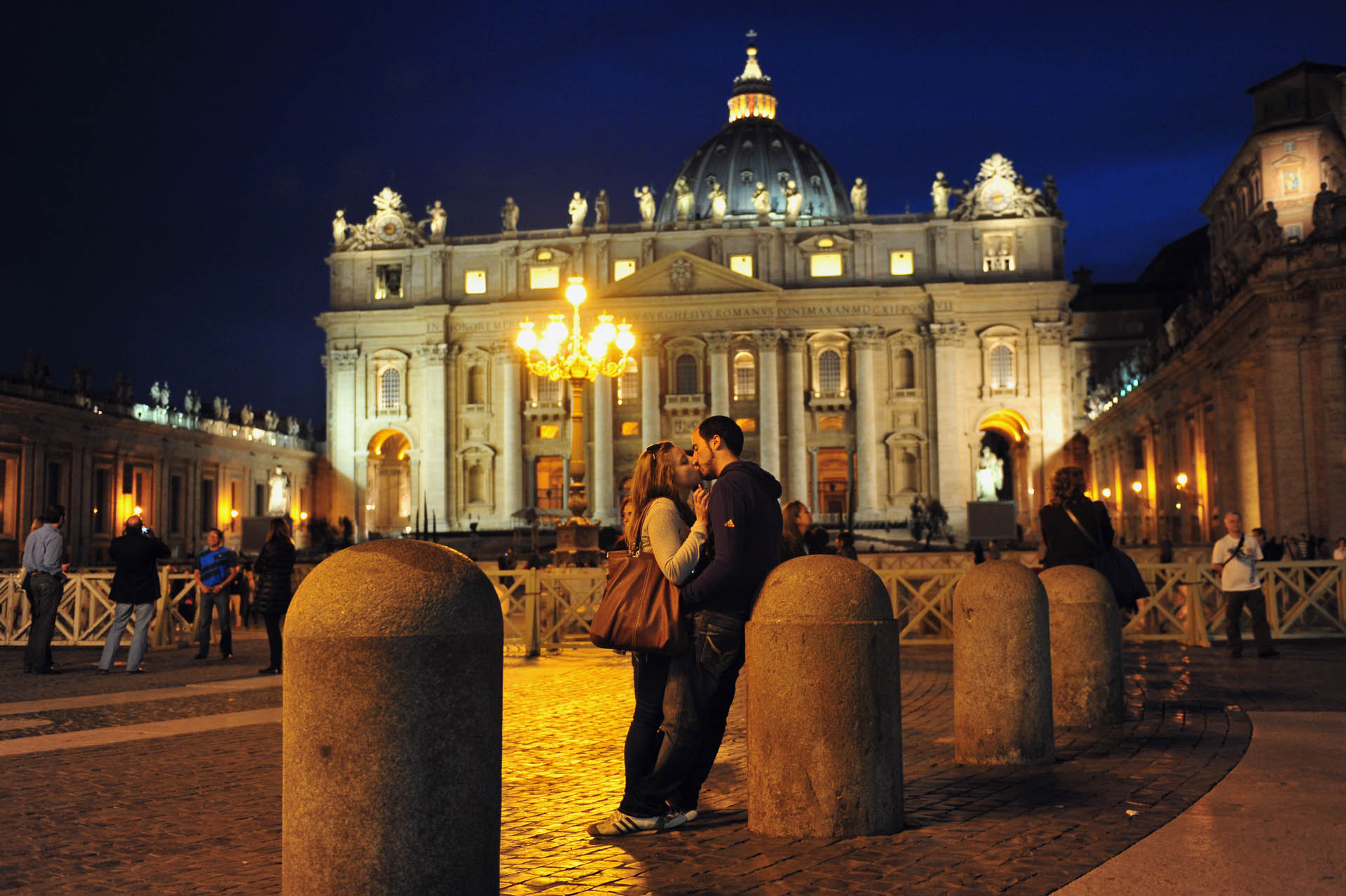 Romantic young adult Italian lovers kiss at Saint Peter's Basilica Vatican city,Italy