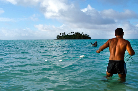 Cook Islands fisherman net fishing in Muri beach lagoon in Rarotonga Cook Islands