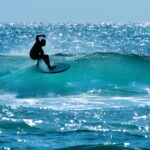 Australian surfer surfing on a large wave on Main Beach in Surfers Paradise Gold Coast Queensland, Australia.