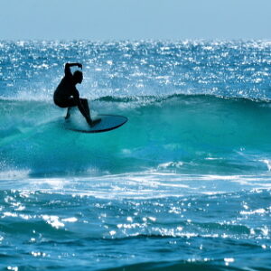 Australian surfer surfing on a large wave on Main Beach in Surfers Paradise Gold Coast Queensland, Australia.