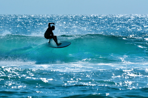 Australian surfer surfing on a large wave on Main Beach in Surfers Paradise Gold Coast Queensland, Australia.