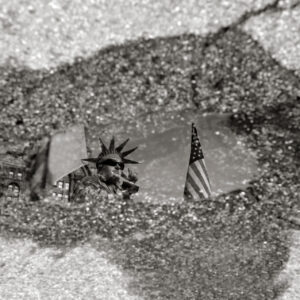 Liberty Sinking -Reflection in water puddle after rain of Statue of liberty Living statue in Battery Park in lower Manhattan, New York City, USA – Fine Arts Photography print for sale. Decoration poster of home or office wall taken by documentary travel photographer Rafael Ben Ari