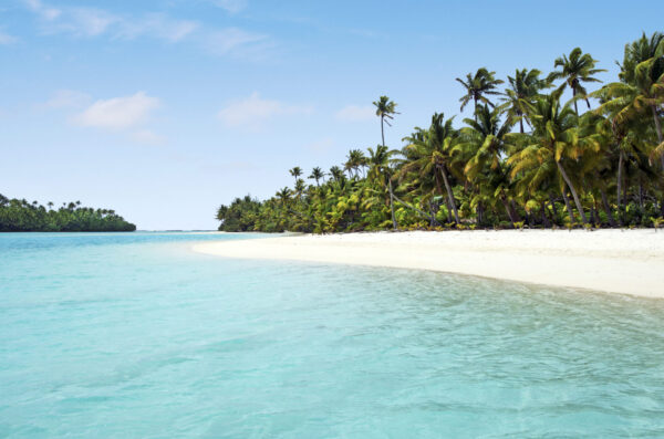 Landscape view of an empty tropical island beach (One Foot Island) in Aitutaki Lagoon, Cook Islands.