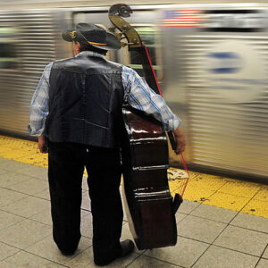 American cowboy carry his Cello waiting for Midnight Train Metropolitan Transportation Subway in New York City USA