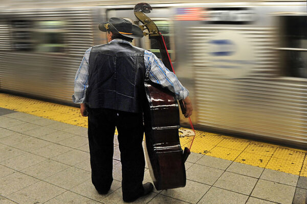 American cowboy carry his Cello waiting for Midnight Train Metropolitan Transportation Subway in New York City USA