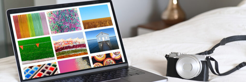 Laptop and camera on a bed. Concept photo of travel photography ,blogging and photographer working from hotel room or home.