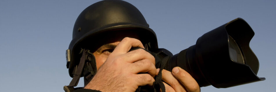 War photographer photographing in a war zone