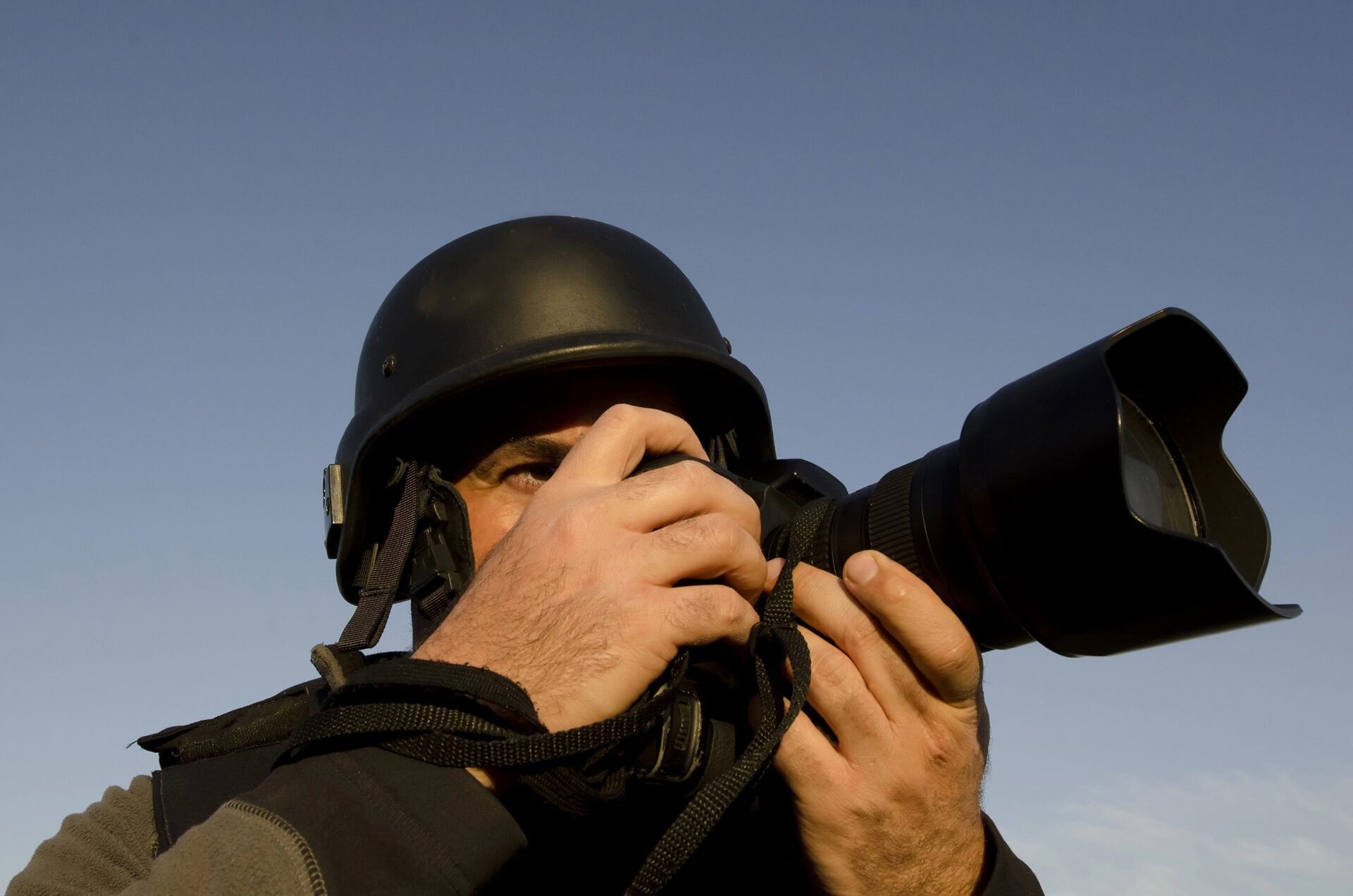 War photographer photographing in a war zone