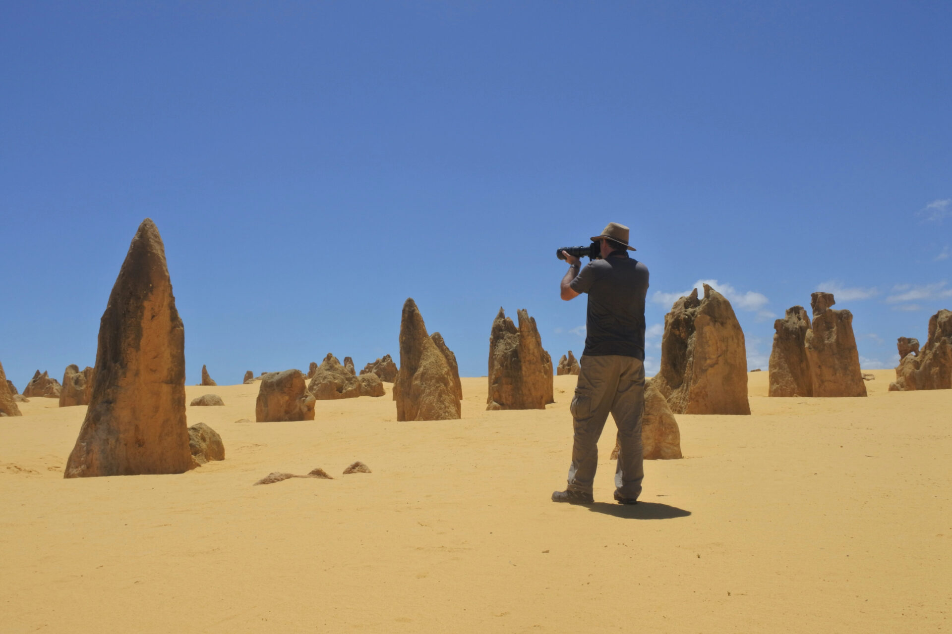 Australian travel photographer photographing The pinnacles desert landscape near Perth in Western Australia. The desert contain thousands of limestone formations called pinnacles.