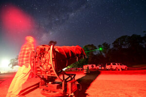 Australian people stargazing with astronomical telescope during winter solstice night