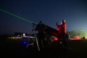 Australian people stargazing with astronomical telescope during winter solstice night