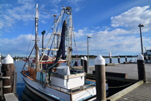 Fishing Trawler moor at fisherman's wharf. Fishing trawler is a special vessel that catches fish by dragging a large net called a trawl through the water.