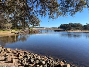 Landscape view of bridge road crossing over Lake Cathie New South Wales Australia
