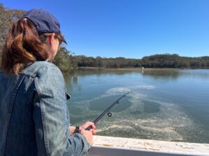 Australian woman fishing at Lake Cathie New South Wales Australia