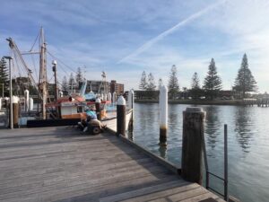 Local person fishing at Haistings River from Fisherman's Wharf Port Macquarie NSW New South Wales, Australia.
