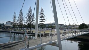 PORT MAQUIRE, NSW - OCT 13 2025:Australian people crossing over Kooloonbung Creek Bridge a cable-stayed bridge that connects the foreshore area of Port Macquarie NSW Australia
