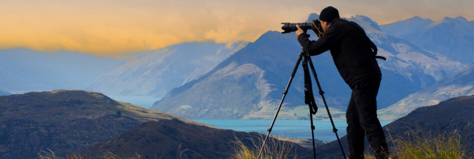 Documentary travel photographer Rafael Ben Ari photographing the landscape view of the Remarkables and Lake Wakatipu in the South Island of New Zealand.