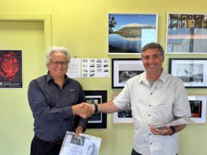 Rafael Ben Ari presenting a certificate to a student at the graduation ceremony for his photography course, The Photographer’s Eye.